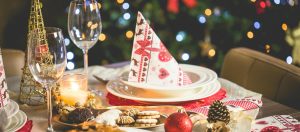 Ein festlich gedeckter Esstisch mit Weihnachtsdeko und Keksen.